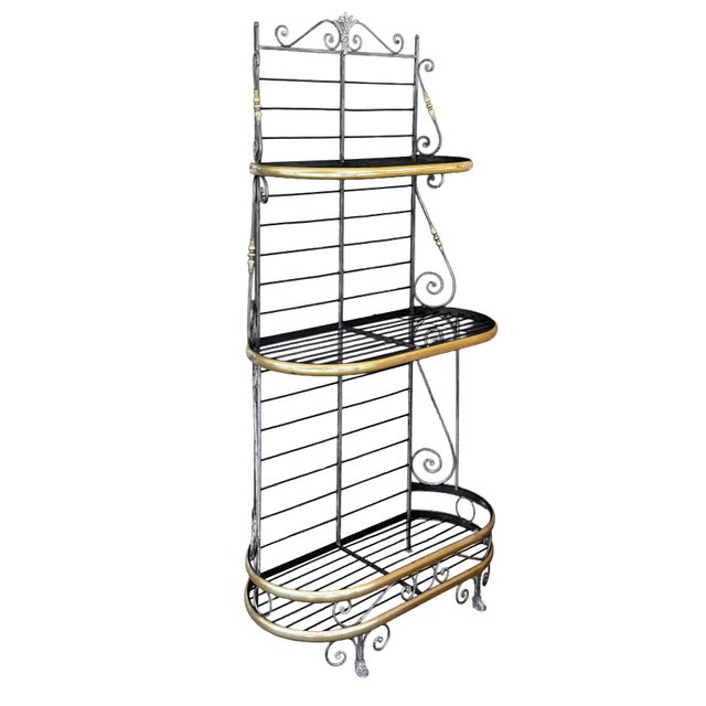 A fine authentic French baker's rack or boulangerie display stand of wrought iron with decorative brass trim and finials,...