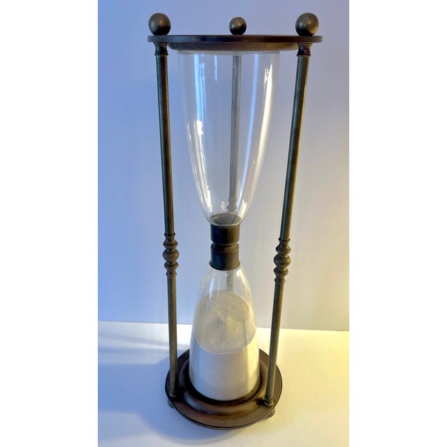 A striking solid brass hourglass / sand timer, standing an impressive 24 inches tall. Sculptural and timeless, it makes a...