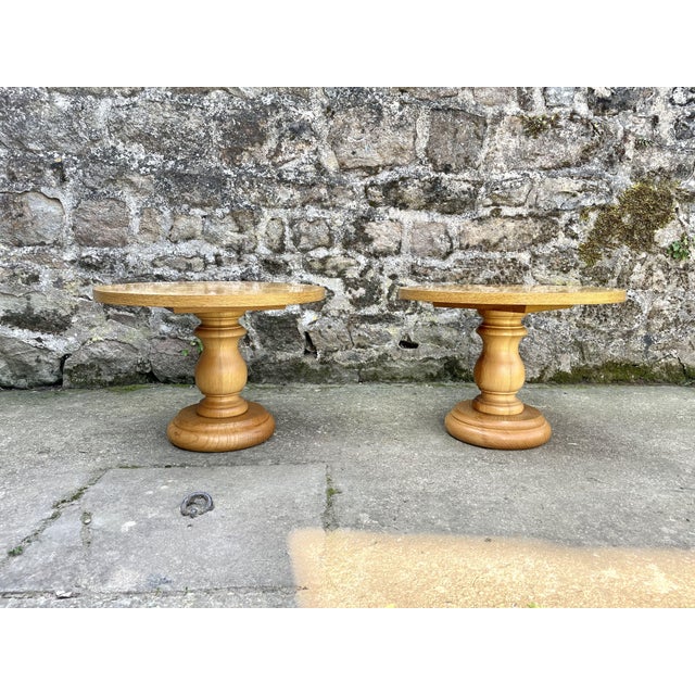 Pair of round coffee tables from the 1980s, Turned wood base and burl top. Some signs of wear on one of the tops (see...