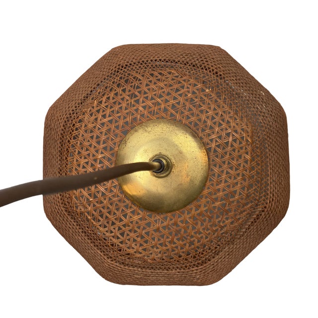 A lovely rattan wicker webbing pendant with brass finial, attributed to Holland, ca 1960s. This rare lamp in in the...