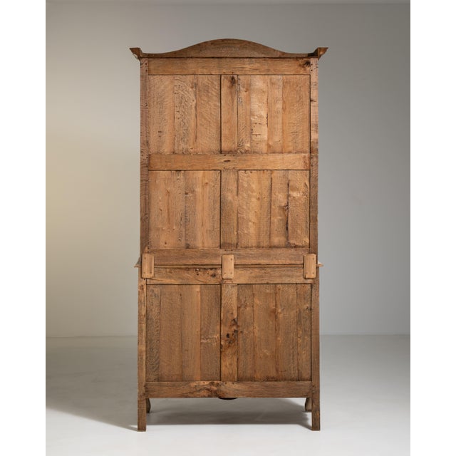 A striking Louis XIV style vitrine showcasing bold structure and classical proportions. The design emphasizes symmetry and...