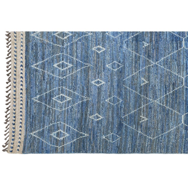 Enhance your space with this handmade Modern Moroccan-style rug crafted from 100% premium wool. The deep indigo blue...