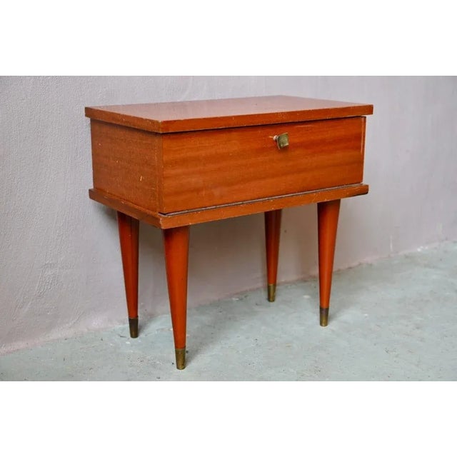 with its spindle base and bright wood stain, this vintage bedside table is elegant and full of charm. Its small original...