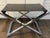 Vintage Mid Century Modern Chrome X-shaped stool. The seat is upholstered with embossed black patent leather to bring a...