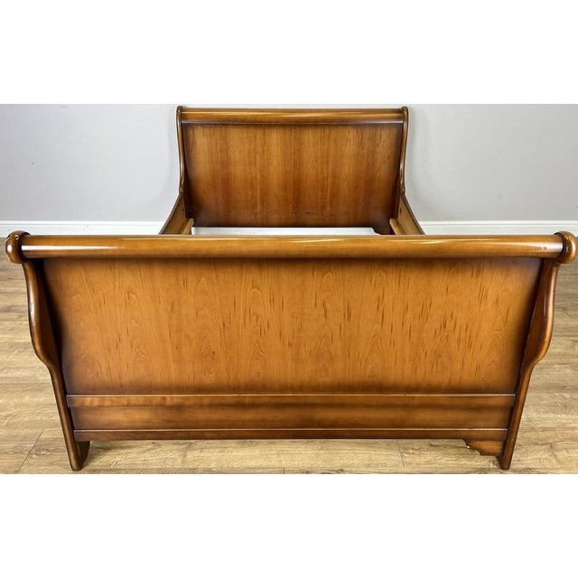 A striking Vintage French double bed with an elegant sleigh-style profile, featuring gracefully curved ends, substantial...