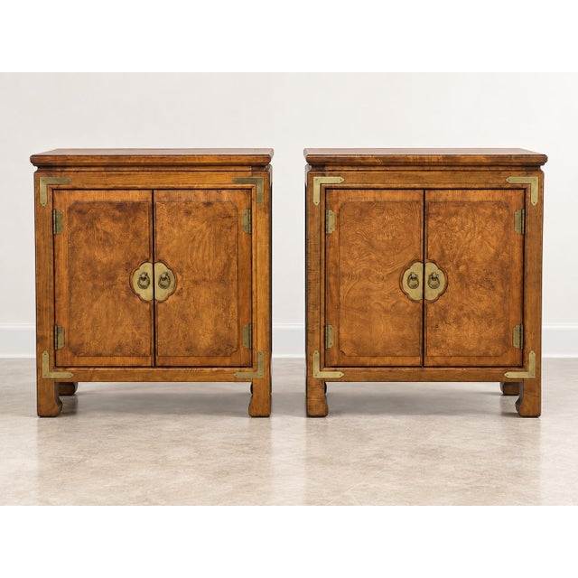 Elevate your bedroom or living space with this striking pair of vintage Campaign-style nightstands by Century Furniture....