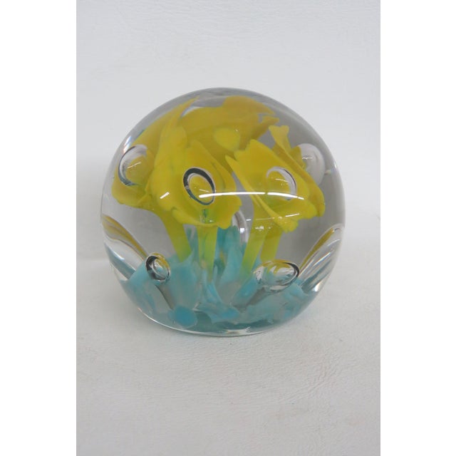 This stunning Yellow Flower Paperweight is made of hand blown glass. This beautiful paperweight has a classic silhouette,...