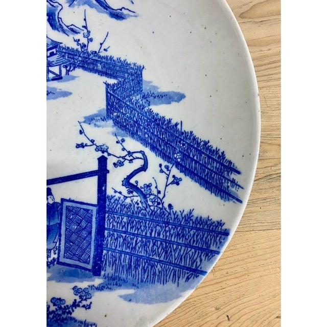 Japanese hand painted Blue and White porcelain charger Plate with pictorial spring country scene. The painting features a...