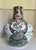 This statement Chinese porcelain vase features richly detailed scenes of court figures, cranes, peonies, birds, and other...
