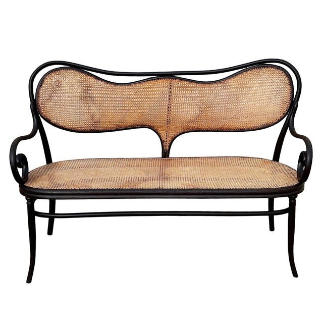 Late Victorian number 5 bentwood settee by Thonet crafted with the companies signature steam-bent beechwood frame, the...