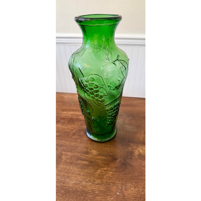 This is a Mid-Century Modern Empoli Verde Vase made in Italy featuring an intricate, relief-like embossed fruit and leaf...