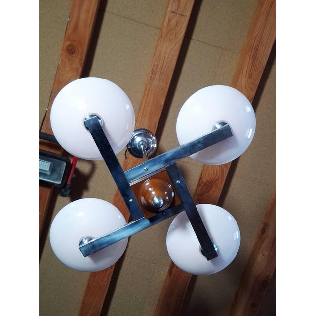 Authentic French chandelier from the 1950s, in an Art Deco/Modernist style. Geometric chrome-plated metal frame, four pale...