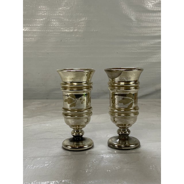 A pair of antique round footed Mercury glass vases or cups.