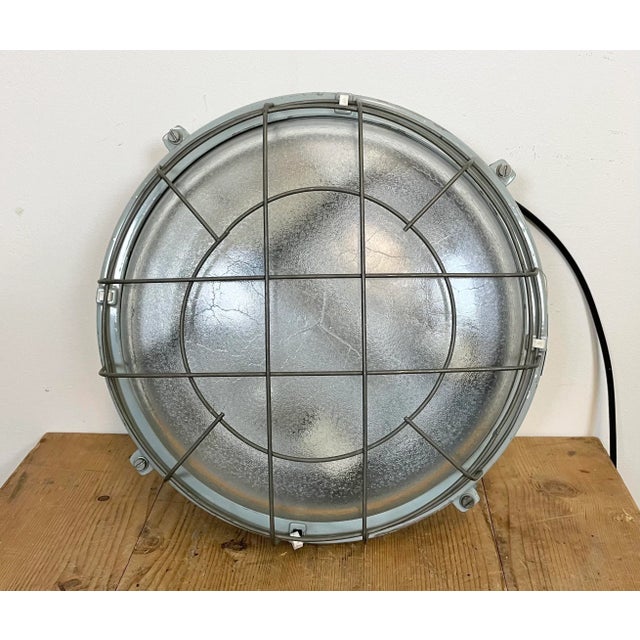 This grey cast aluminium wall lamp was made by Elektrosvit in former Czechoslovakia during the 1980s. . It features a cast...