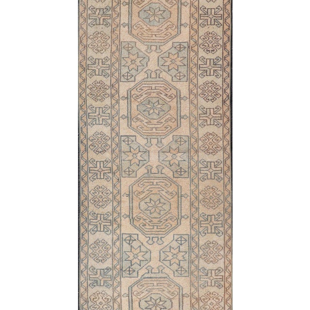 Measures: 2'6 x 11'2 This exquisite vintage Turkish Oushak runner showcases a harmonious blend of muted pastel colors,...