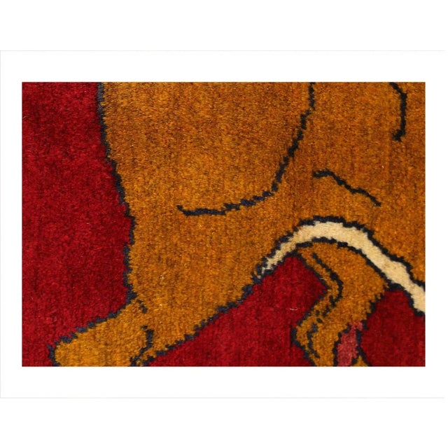 A modern Persian Shiraz small throw rug handmade with a pictorial design of a lion in redover background.