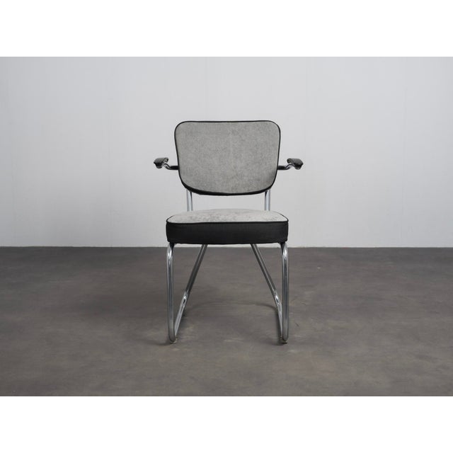 A distinctive dutch modernist armchair produced by ahrend de cirkel in the 1960s. The design combines a chromed tubular...