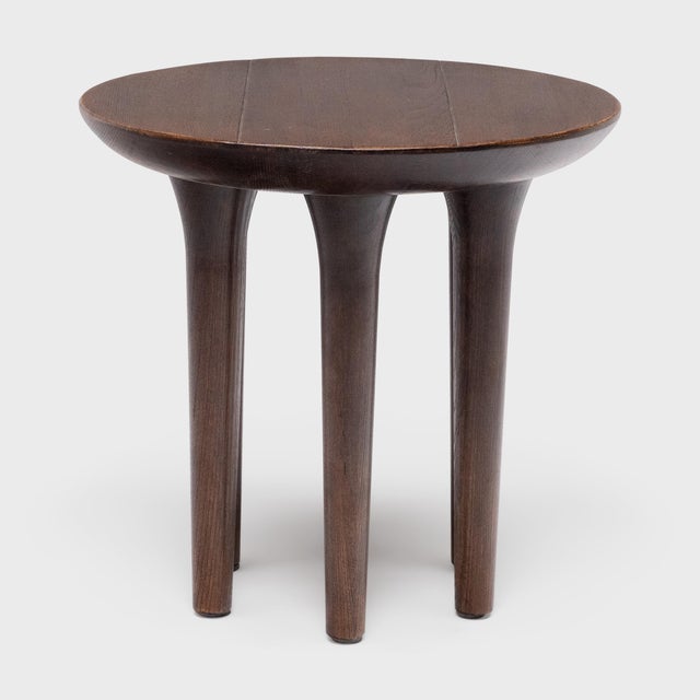 This modern side table has a minimalist form with clean lines and timeless materials. Crafted from reclaimed elm with a...