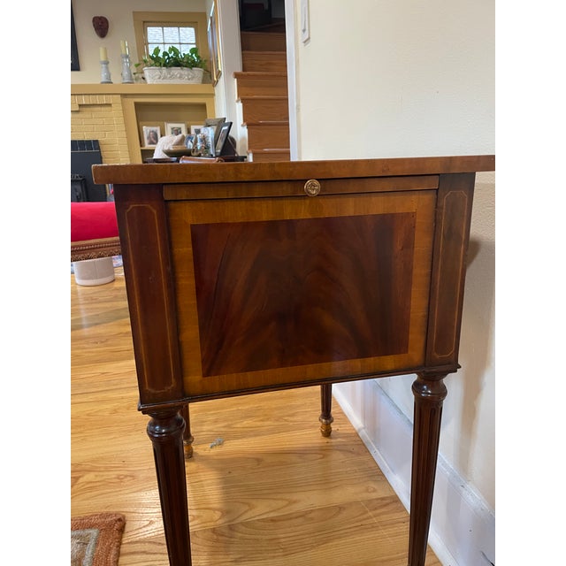 Elegant and versatile, this vintage Maitland-Smith library table features a rich wood finish, leather inset top, and two...