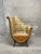 This truly unique vintage fireside armchair features a sweeping high back and a floral damask upholstery fabric with...