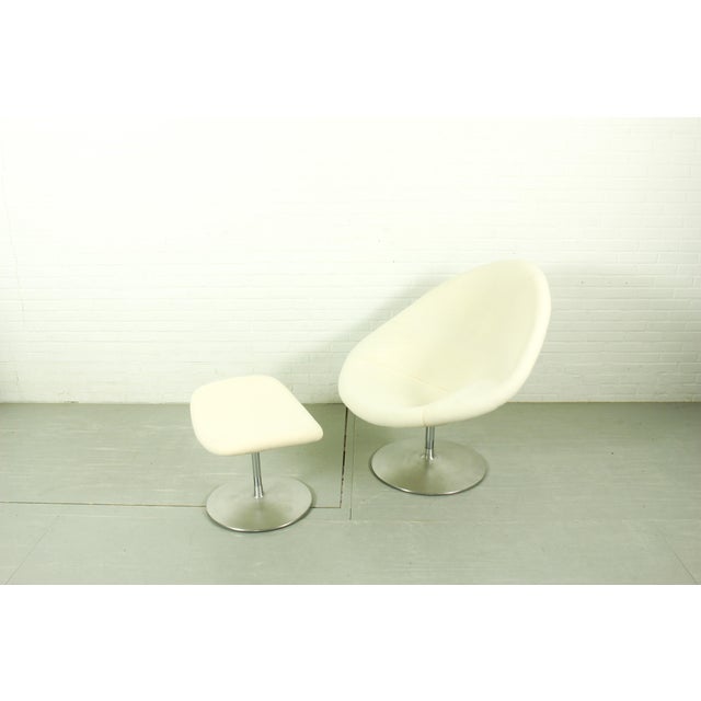 A breathtaking mid-century modern masterpiece: the iconic "globe" swivel lounge chair (model f422) paired with its...