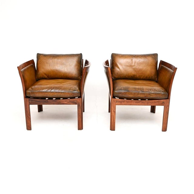 A stylish and very rare pair of vintage Danish armchairs by Illum Wikkelsø. This model is called the ‘Plexus’ armchair. It...