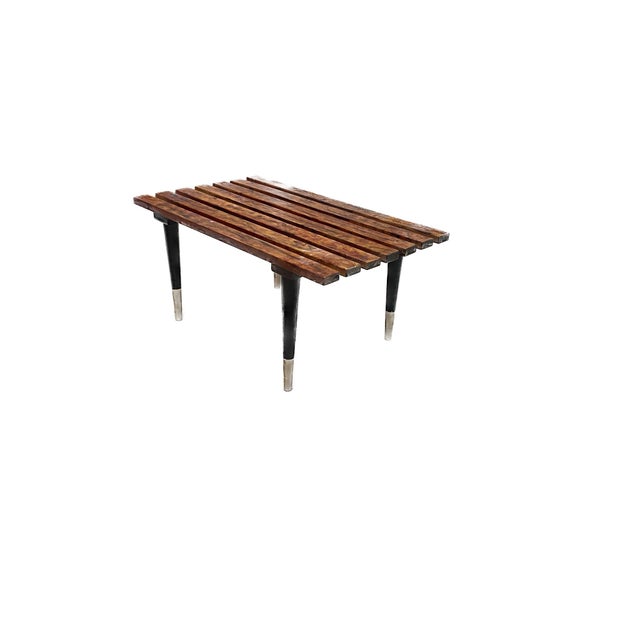 A beautifully restored piece of Mid-Century Modern design, this platform bench epitomizes the elegance and functionality...