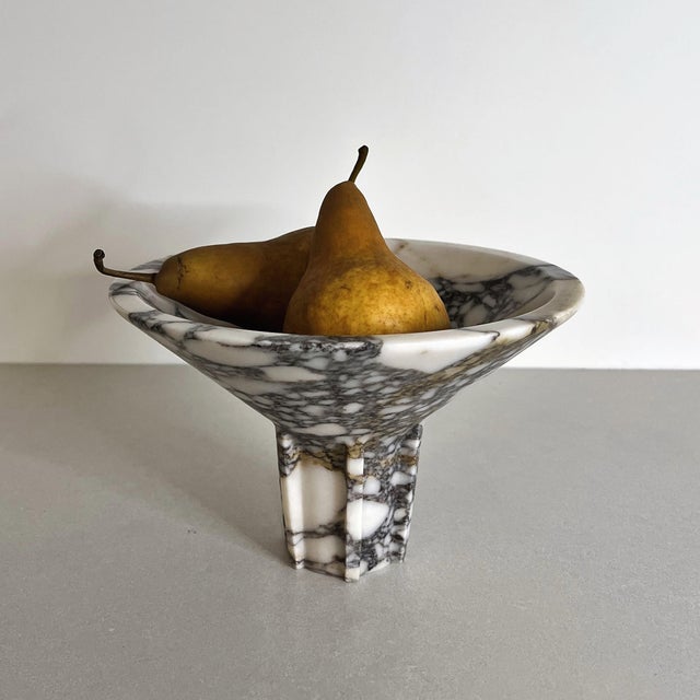 Handcrafted from richly veined white marble, the Navire Bowl features a broad sculptural basin elevated on a strong...