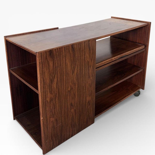 A handsome Danish mid-century media unit crafted in richly grained rosewood, offering clean architectural lines and...