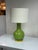Design Plus Gallery presents a Paris Ceramic Table Lamp from Safavieh. The lamp pairs a glossy green ceramic body in a...