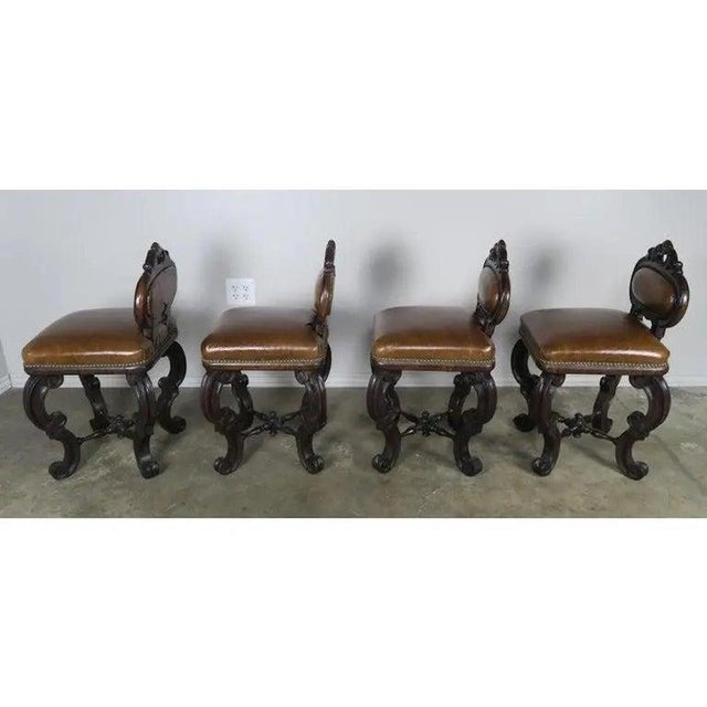 Set of four French embossed leather armchairs upholstered in a leather that resembles crocodile. Great set of petite...