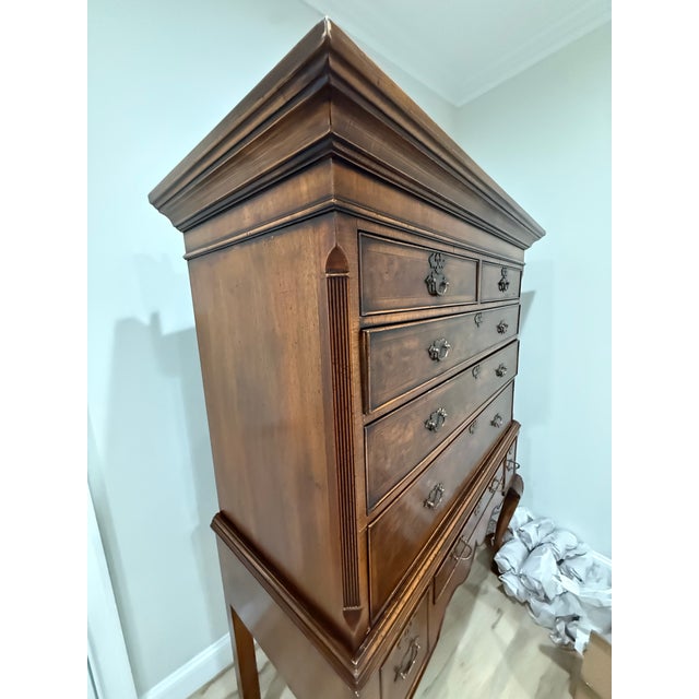 Stunning Queen Anne style highboy chest on stand featuring highly figured, book-matched burl walnut drawer fronts with...