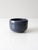 This is a vintage studio pottery bowl. Signed by the artist, the small handmade ceramic bowl has a stormy blue glaze.