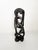 French modernist decorative sculpture dating from the 1980s, carved from dark-stained wood. The composition features an...