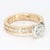 This is an 18k Yellow & White Gold bezel set solitaire ring with a row of diamond accents going down either side of the...