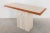Italian Travertine 1970s console table designed by Stone International, Italy. Warm cream and gray stone table top edged...