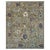 A soft sage green Oushak area rug, its field scattered with oversized palmettes and ragged-edged blossoms in lavender,...