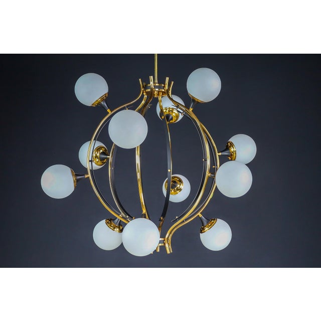 Mid-century stilnovo chandelier in brass and 12 opaline globes, italy 1950s this midcentury italian brass chandelier by...