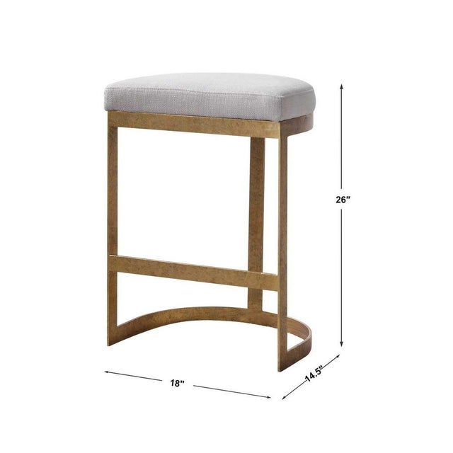 this statement counter stool features a thick hand forged iron base finished in a mottled antique gold leaf. Plush seat is...