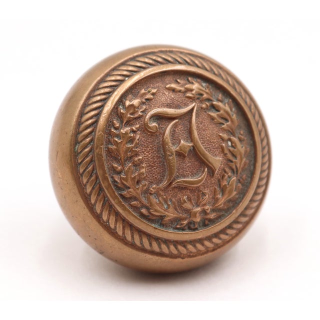 Antique emblematic A passage brass door knob made by Yale & Towne in the 1890s. Good condition with surface wear and...