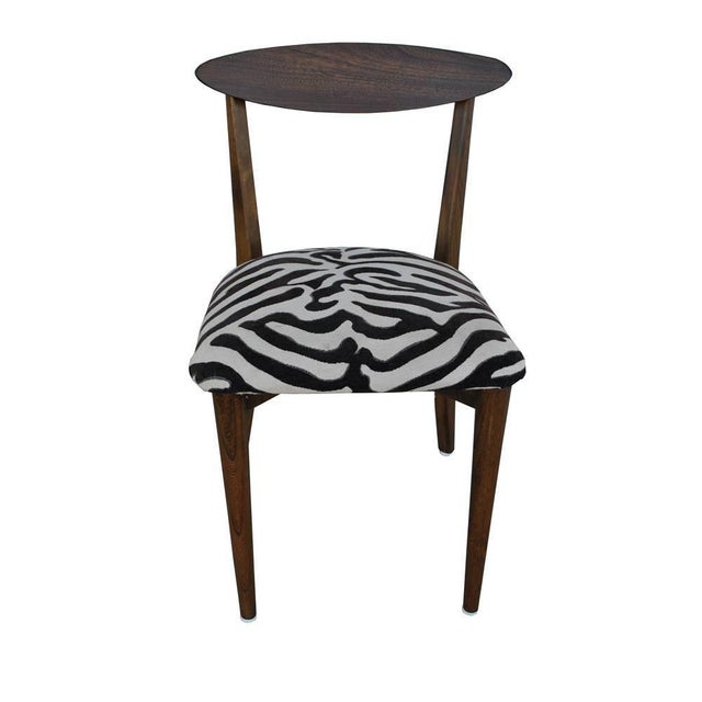 One dining chair in the manner of Kurt Ostervig Danish modern solid wood in a walnut finish in the style of Kurt Ostervig....