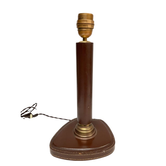 Beautiful leather-covered lamps in the style of Jacques Adnet. Good vintage condition / Lampshade not included. European...