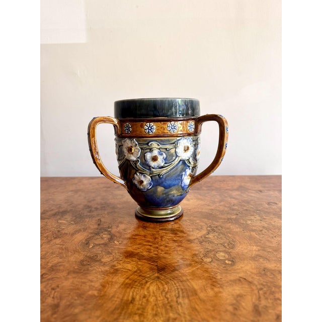 Elegant quality antique Royal Doulton loving cup, having a quality antique Royal Doulton loving cup/vase, having an urn...