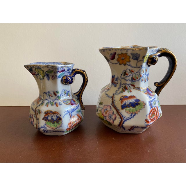 This set of two 19th century Mason's Patent Ironstone China pitchers with hydra hndles is a great addition to any vintage...