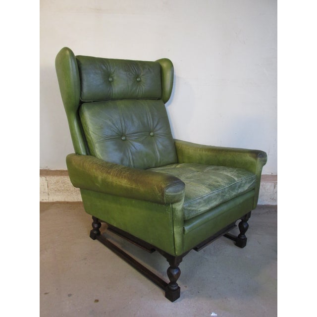 Shabby Mod Danish lounge chair in distressed green leather by Svend Skipper for Mobelfabrik, circa 1970. Oak legs and...