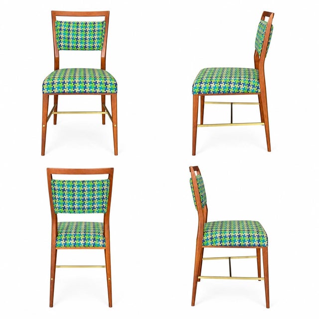 A set of six Paul McCobb “Irwin Collection” dining chairs, crafted in walnut with distinctive brass stretchers and...