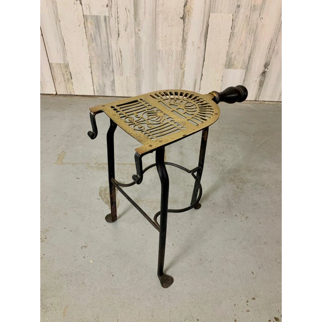 Hand cut brass plate mounted on hand forged iron tripod base with turned-wooden handle. Great fireplace accent or plant...