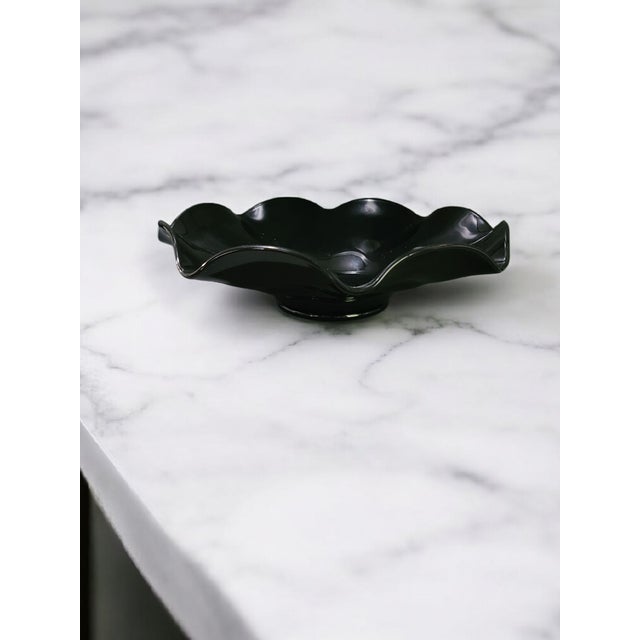 Elevate your home décor with the timeless elegance of this Vintage Art Deco Black Art Glass Scalloped Edge Center Piece...