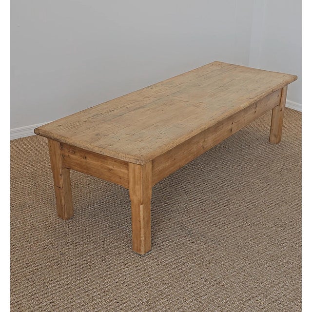 Dimensions: 71.5"W x 26.5"D x 20"H A beautiful antique English pine coffee table showcasing the simple craftsmanship and...