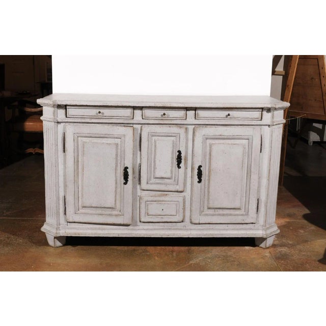 A Swedish Gustavian period painted wood sideboard from the late 18th century, with canted side posts, four drawers and...